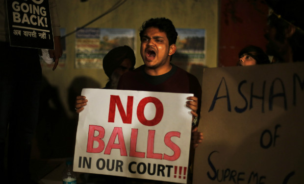 A gay rights activist holds a placard and shouts slogans after the Supreme Court refused to review its December 2013 verdict criminalising gay sex in New Delhi on Tuesday - AP A gay rights activist holds a placard and shouts slogans after the Supreme Court refused to review its December 2013 verdict criminalising gay sex in New Delhi on Tuesday - AP